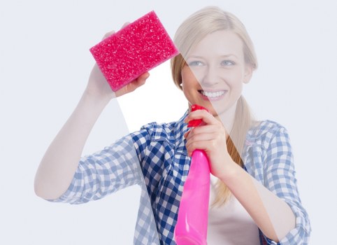 Local technician cleaning curtains in a Brixton living room